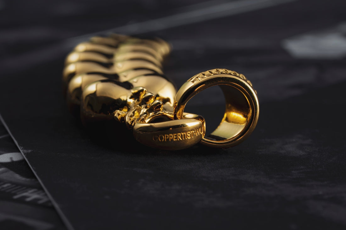 a couple of gold rings sitting on top of a table