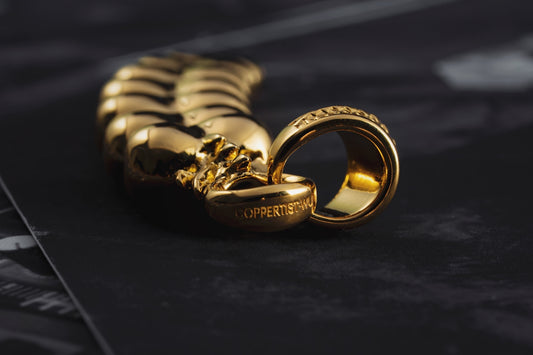 a couple of gold rings sitting on top of a table