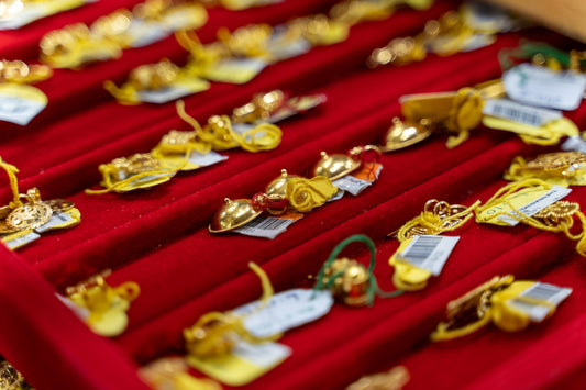 a red velvet box filled with lots of gold jewelry