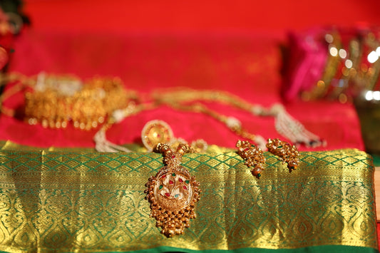 a close up of some gold jewelry on a table
