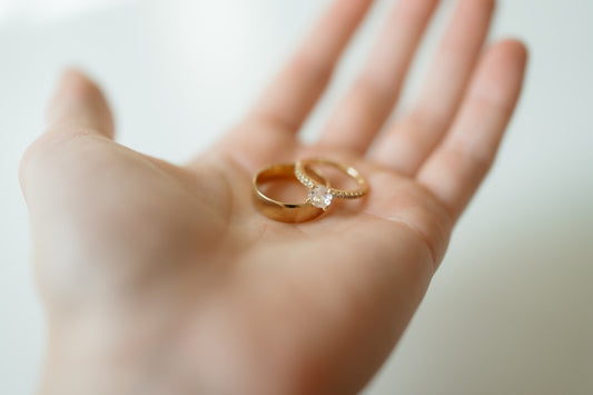 Two golden rings rest on a hand.
